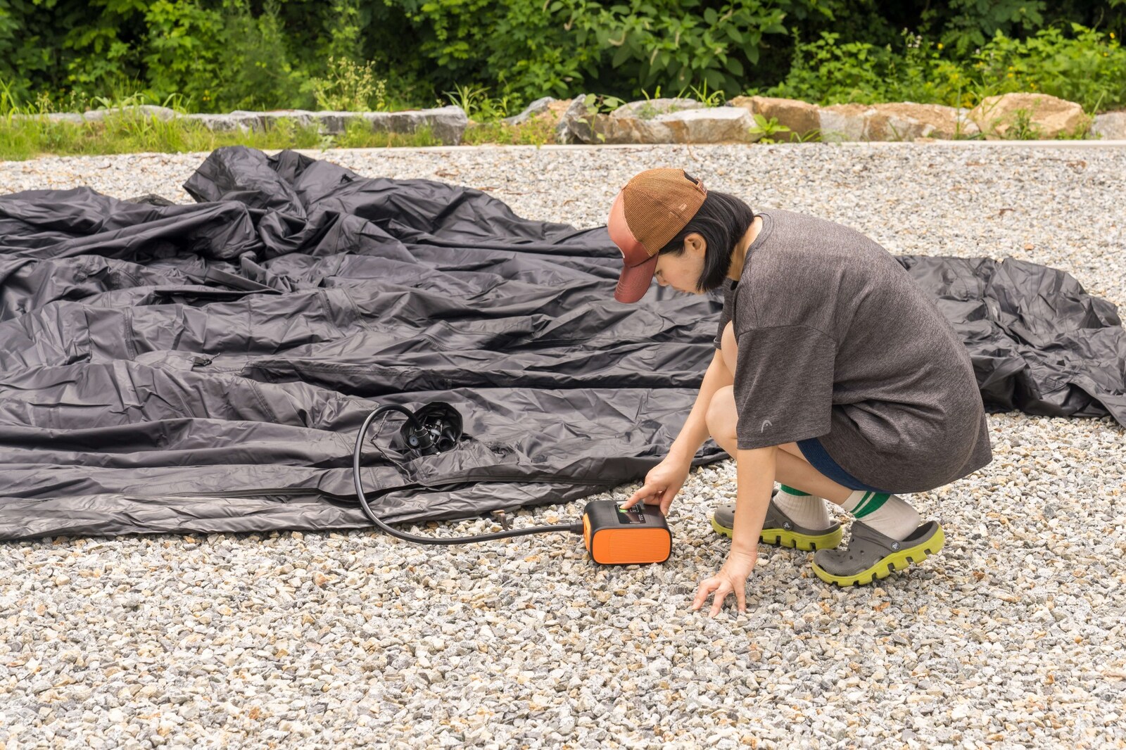 Electric air pump inflating a large outdoor air tent